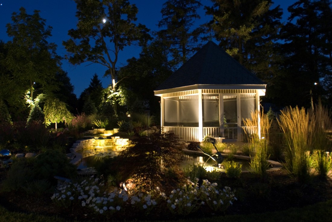 Natural outdoor landscape lighting effects on garden, gazebo and ponds